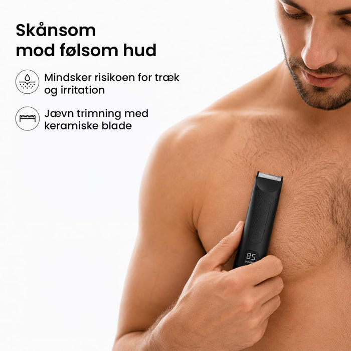 En mand trimmer forsigtigt sit brysthår med en kropshårstrimmer med keramiske knive.
