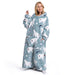 En smilende kvinde iført en blå oversized fleece med isbjørne- og fiskemotiv fra Kroppsbutiken.
