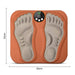 Orange TENS-fodmassagemåtte med fodaftryk, digitalt display, måler 32 x 30 cm og leveres med trådløs fjernbetjening.
